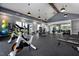 Modern gym with exercise bikes, weight training machines, and mirrored wall at 113 Seagraves Creek Ln, Holly Springs, NC 27540