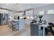 Well-appointed kitchen with stainless steel appliances, ample counter space, and a dining area perfect for gatherings at 113 Seagraves Creek Ln, Holly Springs, NC 27540