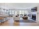 Inviting living area with a fireplace, hardwood floors, and an open layout to the dining and kitchen spaces at 113 Seagraves Creek Ln, Holly Springs, NC 27540
