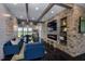 Cozy lounge area with fireplace, stone accent wall, shiplap, and comfortable seating at 113 Seagraves Creek Ln, Holly Springs, NC 27540