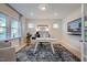 Well-lit office with a neutral color palette, plush rug, and modern fixtures creating a productive workspace at 113 Seagraves Creek Ln, Holly Springs, NC 27540