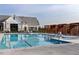 Beautiful community pool area with lounge chairs, pool lift, and clubhouse at 113 Seagraves Creek Ln, Holly Springs, NC 27540