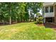 Spacious backyard with mature trees and a view of neighboring homes at 1149 The Preserve Trl, Chapel Hill, NC 27517