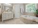 Bright primary bathroom featuring a soaking tub, walk-in shower, and updated cabinetry at 1149 The Preserve Trl, Chapel Hill, NC 27517