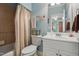 Well-lit bathroom with a shower tub, neutral walls, white vanity and framed mirror at 1149 The Preserve Trl, Chapel Hill, NC 27517