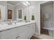 Bright bathroom featuring a long white vanity with double sinks and large framed mirror at 1149 The Preserve Trl, Chapel Hill, NC 27517