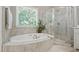 Bright bathroom featuring a soaking tub, walk-in shower, and large window at 1149 The Preserve Trl, Chapel Hill, NC 27517