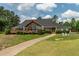 Scenic view of the clubhouse with an inviting deck, landscaped grounds, and Adirondack chairs at 1149 The Preserve Trl, Chapel Hill, NC 27517