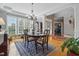 Sunlit dining room with hardwood floors, area rug, and elegant chandelier at 1149 The Preserve Trl, Chapel Hill, NC 27517