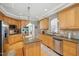 Bright kitchen with stainless steel appliances, granite countertops and a central island at 1149 The Preserve Trl, Chapel Hill, NC 27517