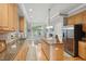 Well-appointed kitchen with wooden cabinetry, granite countertops, a central island, and stainless steel appliances at 1149 The Preserve Trl, Chapel Hill, NC 27517