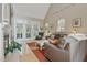 Bright living room with a fireplace, large windows, and comfortable sofas at 1149 The Preserve Trl, Chapel Hill, NC 27517