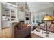 Cozy living room featuring a fireplace, built-in bookshelves, and large windows for natural light at 1149 The Preserve Trl, Chapel Hill, NC 27517