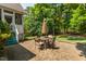 Enjoy the backyard on this brick paver patio with an outdoor table, four chairs, and a large umbrella at 1149 The Preserve Trl, Chapel Hill, NC 27517