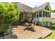 Brick patio with an outdoor seating area and well-manicured backyard of a brick home at 1149 The Preserve Trl, Chapel Hill, NC 27517