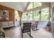 Cozy sunroom featuring tile floors, exposed brick, and vaulted ceilings at 1149 The Preserve Trl, Chapel Hill, NC 27517