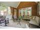 Bright sunroom featuring exposed brick, tile floors, and white trim at 1149 The Preserve Trl, Chapel Hill, NC 27517