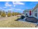 Lush backyard with outdoor seating, grill and a line of trees offering privacy and shade at 1206 Newton Dr Dr, Mebane, NC 27302