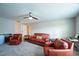 Spacious living room with leather seating, ceiling fan, and good lighting at 1206 Newton Dr Dr, Mebane, NC 27302