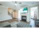 Comfortable living room with a fireplace, ceiling fan, and stairs leading to the next level at 1206 Newton Dr Dr, Mebane, NC 27302