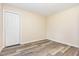Minimalist bedroom with gray wood-look floors and bright white closet door at 121 Lena Ct, Burlington, NC 27217