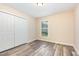 Bedroom features gray wood-look floors, a window, and a closet at 121 Lena Ct, Burlington, NC 27217
