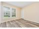 Neutral bedroom with natural light from a window and gray wood-look flooring at 121 Lena Ct, Burlington, NC 27217
