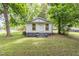 Cute home exterior with a small yard surrounded by mature trees for privacy at 121 Lena Ct, Burlington, NC 27217