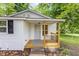 Charming front porch with wood deck, black railings, and stylish black and white rug at 121 Lena Ct, Burlington, NC 27217