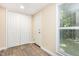 Hallway featuring gray wood-look floors, a closet and a window at 121 Lena Ct, Burlington, NC 27217