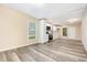 Bright kitchen featuring white cabinetry, stainless steel appliances, and durable gray wood-look flooring at 121 Lena Ct, Burlington, NC 27217