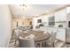 Eat-in kitchen featuring white cabinets, stainless steel appliances, and modern flooring at 121 Lena Ct, Burlington, NC 27217