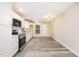 Bright kitchen featuring white cabinets, stainless steel appliances, and modern flooring at 121 Lena Ct, Burlington, NC 27217