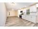 Bright kitchen featuring white cabinets, stainless steel appliances, and modern flooring at 121 Lena Ct, Burlington, NC 27217