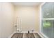 Utility room with gray wood-look flooring, large window and utility hookups at 121 Lena Ct, Burlington, NC 27217
