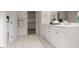 Bright bathroom featuring double vanity with white cabinets and access to a walk-in closet at 1216 Hardin Hill Ln, Knightdale, NC 27545