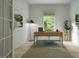 Bright home office with neutral walls, modern desk, and natural light from a large window at 1216 Hardin Hill Ln, Knightdale, NC 27545