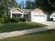 Charming single-story home featuring a well-maintained lawn and an attached two-car garage at 126 Kipling Dr, Oxford, NC 27565