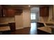 Well-designed kitchen featuring ample cabinetry, granite counters, wood flooring and an adjacent living space at 126 Kipling Dr, Oxford, NC 27565
