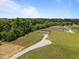 Aerial view of several homes on large lots, each with a long gravel driveway at 130 Ruby Trl, Roxboro, NC 27574