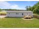 View of the back of the home showing the back porch and fenced-in backyard at 130 Ruby Trl, Roxboro, NC 27574