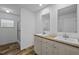 Bright bathroom featuring double sinks with framed mirrors and a glass-enclosed shower at 130 Ruby Trl, Roxboro, NC 27574
