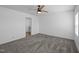 A carpeted bedroom features a ceiling fan and an en suite bathroom at 130 Ruby Trl, Roxboro, NC 27574
