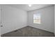 Carpeted bedroom featuring window and a closet at 130 Ruby Trl, Roxboro, NC 27574