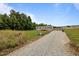 Front of the home featuring a gravel driveway and landscaping at 130 Ruby Trl, Roxboro, NC 27574