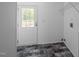 This laundry room features grey marble pattern flooring, a white door, and metal shelving at 130 Ruby Trl, Roxboro, NC 27574