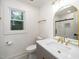 Stylish bathroom with a marble countertop vanity, gold hardware, modern fixtures, patterned tile, and a glass door shower at 1308 Broken Branch Ct, Raleigh, NC 27610