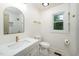 Well-lit bathroom with a marble-top vanity, gold fixtures, white tile shower, and patterned tile flooring at 1308 Broken Branch Ct, Raleigh, NC 27610