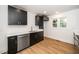 Modern kitchen features black cabinets, stainless steel appliances, white countertops, and wood-look flooring at 1308 Broken Branch Ct, Raleigh, NC 27610