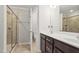 Bathroom featuring double sinks, walk-in shower, and private toilet area, offering luxury and functionality at 136 Thornhill Dr, Burlington, NC 27215
